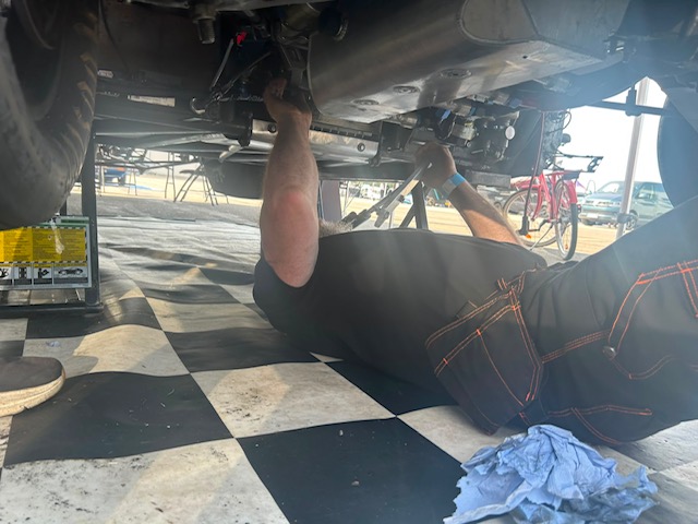 Under the car looking for the fault